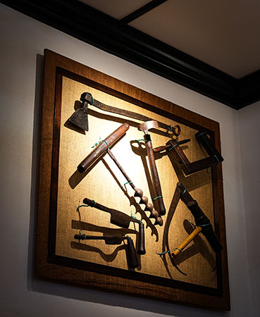 Image of old tools used on Plantation that used to hang in the Old Lahaina Courthouse